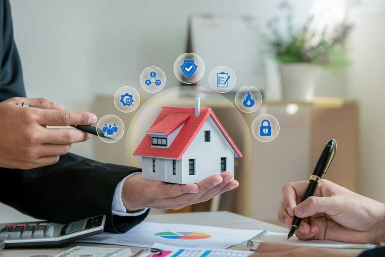 A family reviews insurance documents together at their kitchen table, looking over papers and a laptop.